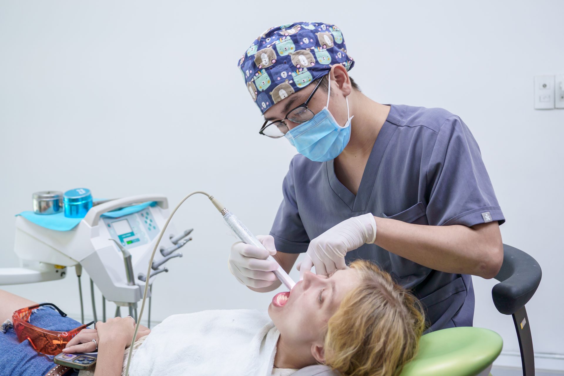 Dentist examining patient smile at Picasso Dental Clinic