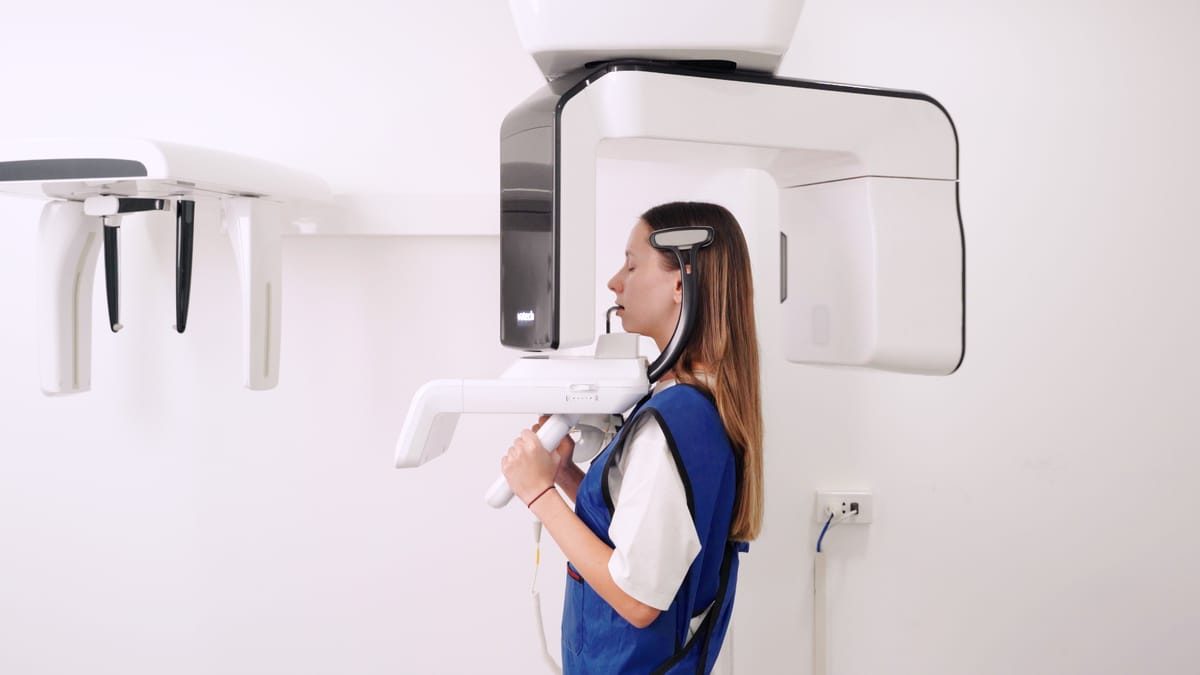 A patient receiving a Cone Beam CT scan at Picasso Dental before implant surgical planning